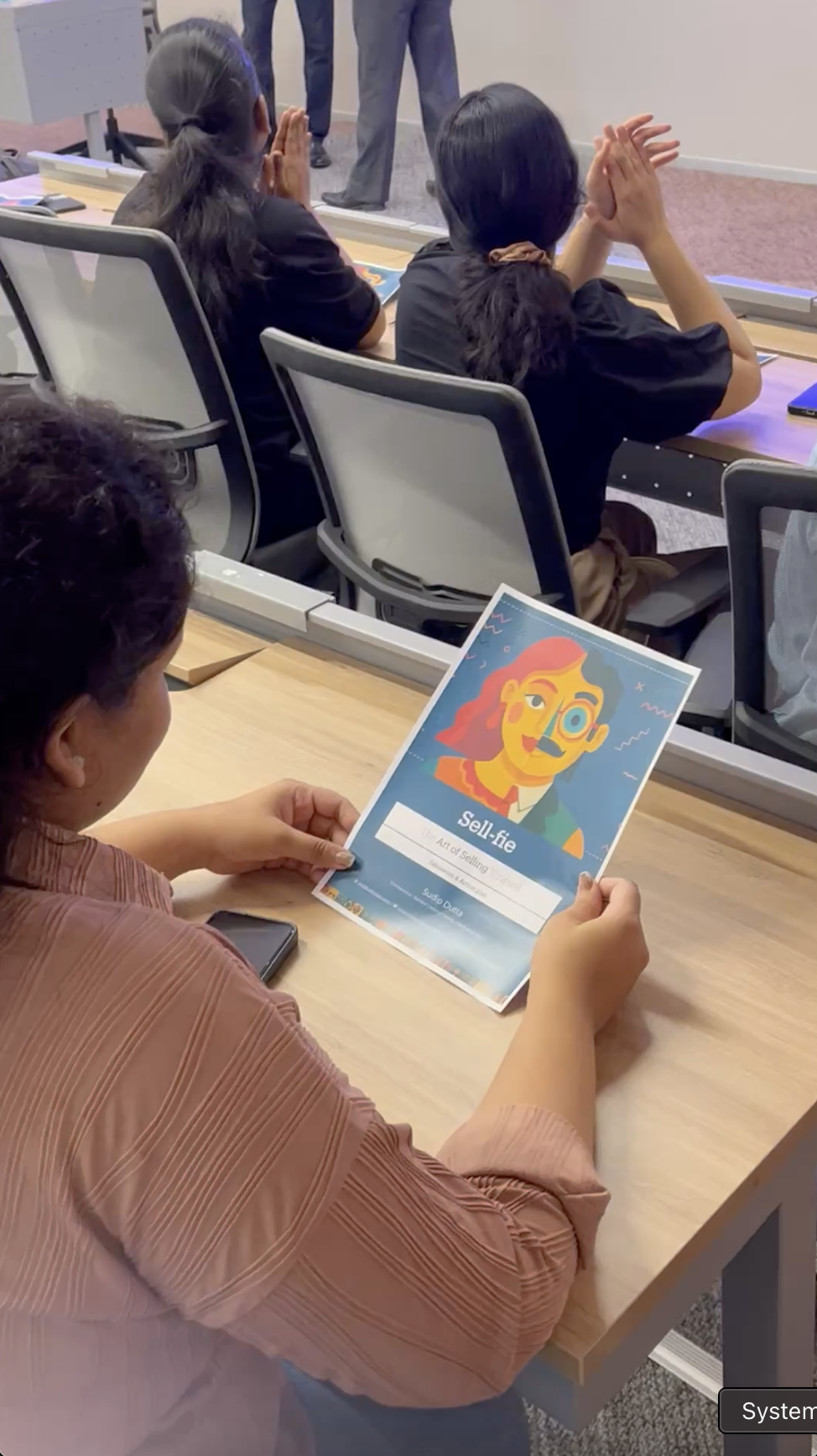 A participant holding Sell-fie session materials